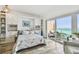 Bedroom with ocean view, built-in cabinets, and access to outdoor balcony at 880 Mandalay Ave # N607, Clearwater Beach, FL 33767