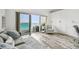 Bright living room featuring access to a balcony with ocean views and built-in shelving at 880 Mandalay Ave # N607, Clearwater Beach, FL 33767
