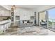 Living space with couch, coastal decor, built-in cabinets, and access to the balcony at 880 Mandalay Ave # N607, Clearwater Beach, FL 33767