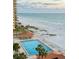 Breathtaking ocean view overlooking a large swimming pool with palm trees and lounge chairs at 880 Mandalay Ave # N607, Clearwater Beach, FL 33767
