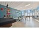 Spacious recreation room features pool and ping pong tables, seating, and floor-to-ceiling ocean views at 880 Mandalay Ave # N607, Clearwater Beach, FL 33767
