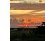 Beautiful sunset over the ocean with vibrant orange and yellow colors reflecting on the water at 880 Mandalay Ave # N607, Clearwater Beach, FL 33767