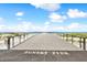 Long pier extending over the beach, offering stunning ocean and sunset views at 880 Mandalay Ave # N607, Clearwater Beach, FL 33767