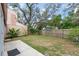 Private backyard area with mature trees and lawn at 9466 Forest Hills Cir, Tampa, FL 33612