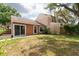 Fenced backyard with sliding glass doors leading to a patio area, perfect for outdoor entertaining at 9466 Forest Hills Cir, Tampa, FL 33612