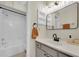Well lit bathroom with modern finishes including a bathtub and new vanity with matte black hardware at 9466 Forest Hills Cir, Tampa, FL 33612