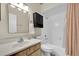 Clean bathroom with a single sink vanity, toilet, and shower/tub combo with new fixtures and lighting at 9466 Forest Hills Cir, Tampa, FL 33612