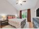 Well-lit bedroom with laminate floors, a ceiling fan, dark window treatments, and modern furnishings at 9466 Forest Hills Cir, Tampa, FL 33612