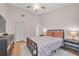 Bedroom features a ceiling fan, closet and a double bed with matching bedside tables and lamps at 9466 Forest Hills Cir, Tampa, FL 33612