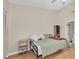 Cozy bedroom features wood floors, light-colored walls, a bed, and direct access to the bathroom at 9466 Forest Hills Cir, Tampa, FL 33612