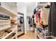 Spacious walk-in closet with shelving, hanging racks, plenty of room for shoes, and a mirror at 9466 Forest Hills Cir, Tampa, FL 33612