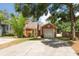 Charming single-Gathering home with a well-maintained lawn and a one-car garage on a sunny day at 9466 Forest Hills Cir, Tampa, FL 33612