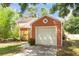 Close-up of the one-car garage featuring an exterior composed of shingle siding at 9466 Forest Hills Cir, Tampa, FL 33612