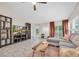 Spacious living room features tile flooring, large windows, and backyard views at 9466 Forest Hills Cir, Tampa, FL 33612