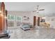 Bright living area featuring tile floors, large windows, and access to the backyard at 9466 Forest Hills Cir, Tampa, FL 33612