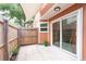 Enclosed patio with stone pavers, plants, and a partial fence, providing a secluded outdoor retreat at 9466 Forest Hills Cir, Tampa, FL 33612