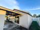 Covered back patio, gravel, and sliding glass doors to the backyard at 9735 Riverchase Dr, New Port Richey, FL 34655