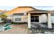 Covered back patio, gravel, and sliding glass doors to the backyard at 9735 Riverchase Dr, New Port Richey, FL 34655