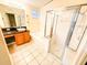 Bright bathroom featuring a soaking tub, a glass-enclosed shower, and a vessel sink at 9735 Riverchase Dr, New Port Richey, FL 34655