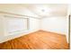 Bright bedroom featuring hardwood floors, a ceiling fan, and a window providing natural light at 9735 Riverchase Dr, New Port Richey, FL 34655