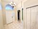 Welcoming foyer with tile flooring, chandelier, and natural light at 9735 Riverchase Dr, New Port Richey, FL 34655