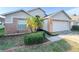 Charming single-story home featuring a two-car garage, brick accents, and a well-maintained front yard at 9735 Riverchase Dr, New Port Richey, FL 34655