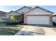 Charming single-story home featuring a two-car garage, brick accents, and a well-maintained front yard at 9735 Riverchase Dr, New Port Richey, FL 34655