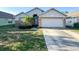 Charming single-story home featuring a two-car garage, brick accents, and a well-maintained front yard at 9735 Riverchase Dr, New Port Richey, FL 34655