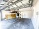 Spacious garage with open ceiling, water heater and room for storage and vehicles at 9735 Riverchase Dr, New Port Richey, FL 34655