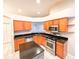 Kitchen with island, stainless steel appliances, granite countertops, and wood cabinets at 9735 Riverchase Dr, New Port Richey, FL 34655