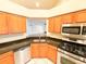Bright kitchen features stainless steel appliances, granite countertops, and wood cabinets at 9735 Riverchase Dr, New Port Richey, FL 34655