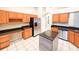 Spacious kitchen features stainless steel appliances, island, and ample counter space at 9735 Riverchase Dr, New Port Richey, FL 34655