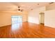 Bright living room with hardwood floors and sliding glass doors to the backyard at 9735 Riverchase Dr, New Port Richey, FL 34655