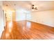Spacious living room with hardwood flooring, ceiling fan, and natural light at 9735 Riverchase Dr, New Port Richey, FL 34655