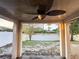 Covered patio with ceiling fan overlooking a large backyard with new fence at 9735 Riverchase Dr, New Port Richey, FL 34655