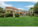 Exterior of home with large backyard and screened-in pool; perfect for entertaining at 10205 Deercliff Dr, Tampa, FL 33647