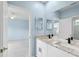 Bathroom with double sinks, stone countertops and a door to the bedroom at 10205 Deercliff Dr, Tampa, FL 33647