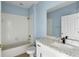 Bathroom featuring modern vanity with sleek fixtures and tiled shower over tub at 10205 Deercliff Dr, Tampa, FL 33647