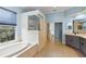 The bathroom boasts double sinks, a glass enclosed shower, and a soaking tub at 10205 Deercliff Dr, Tampa, FL 33647