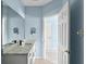 Bright bathroom featuring a double vanity with stone countertop and undermount sinks at 10205 Deercliff Dr, Tampa, FL 33647