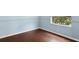 Bedroom features hardwood floors, neutral walls, and window with a wooded view at 10205 Deercliff Dr, Tampa, FL 33647