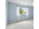 A bedroom featuring neutral carpet, natural light, and light blue walls at 10205 Deercliff Dr, Tampa, FL 33647