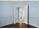 Inviting bedroom showcases neutral paint, white trim, and an open doorway to the rest of the home at 10205 Deercliff Dr, Tampa, FL 33647