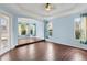 A bonus room offers ample natural light from large windows and beautiful wood flooring at 10205 Deercliff Dr, Tampa, FL 33647