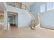 Light-filled foyer with curved staircase and balcony at 10205 Deercliff Dr, Tampa, FL 33647