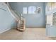 Spacious foyer with curved staircase and natural light at 10205 Deercliff Dr, Tampa, FL 33647