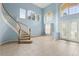 Grand foyer featuring a curved staircase and tall windows at 10205 Deercliff Dr, Tampa, FL 33647