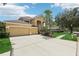 Charming two-story home with a well-manicured lawn, mature landscaping, and a spacious driveway at 10205 Deercliff Dr, Tampa, FL 33647
