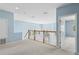 Bright hallway with carpeted floor, natural light, and a white banister at 10205 Deercliff Dr, Tampa, FL 33647