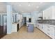 Bright, open kitchen features stainless appliances, center island and mosaic tile backsplash at 10205 Deercliff Dr, Tampa, FL 33647